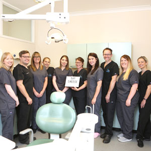 Dentist team with ‘Say Cheese’ sign