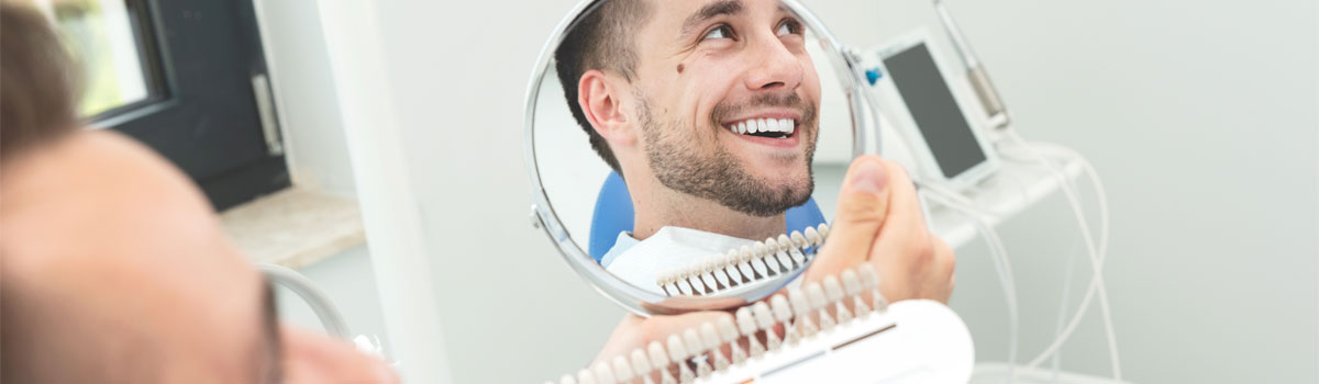 Man in dentist chair with new dental implant