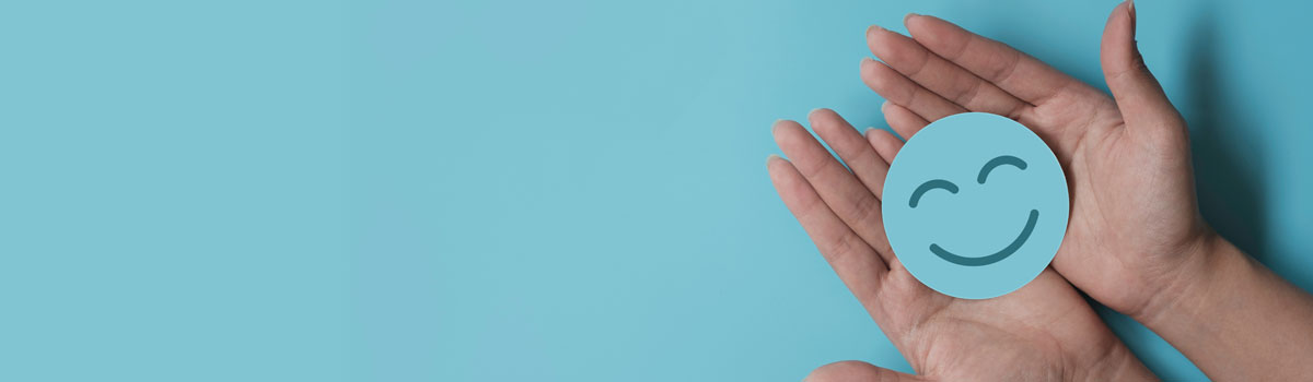 Hand holding smile icon