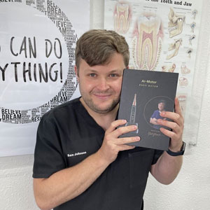 Dentist holding up Endodontics book