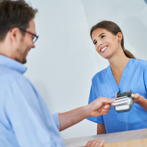 Man paying for dental treatment