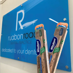 Toothbrushes next to Ruabon Road Dental Practice sign